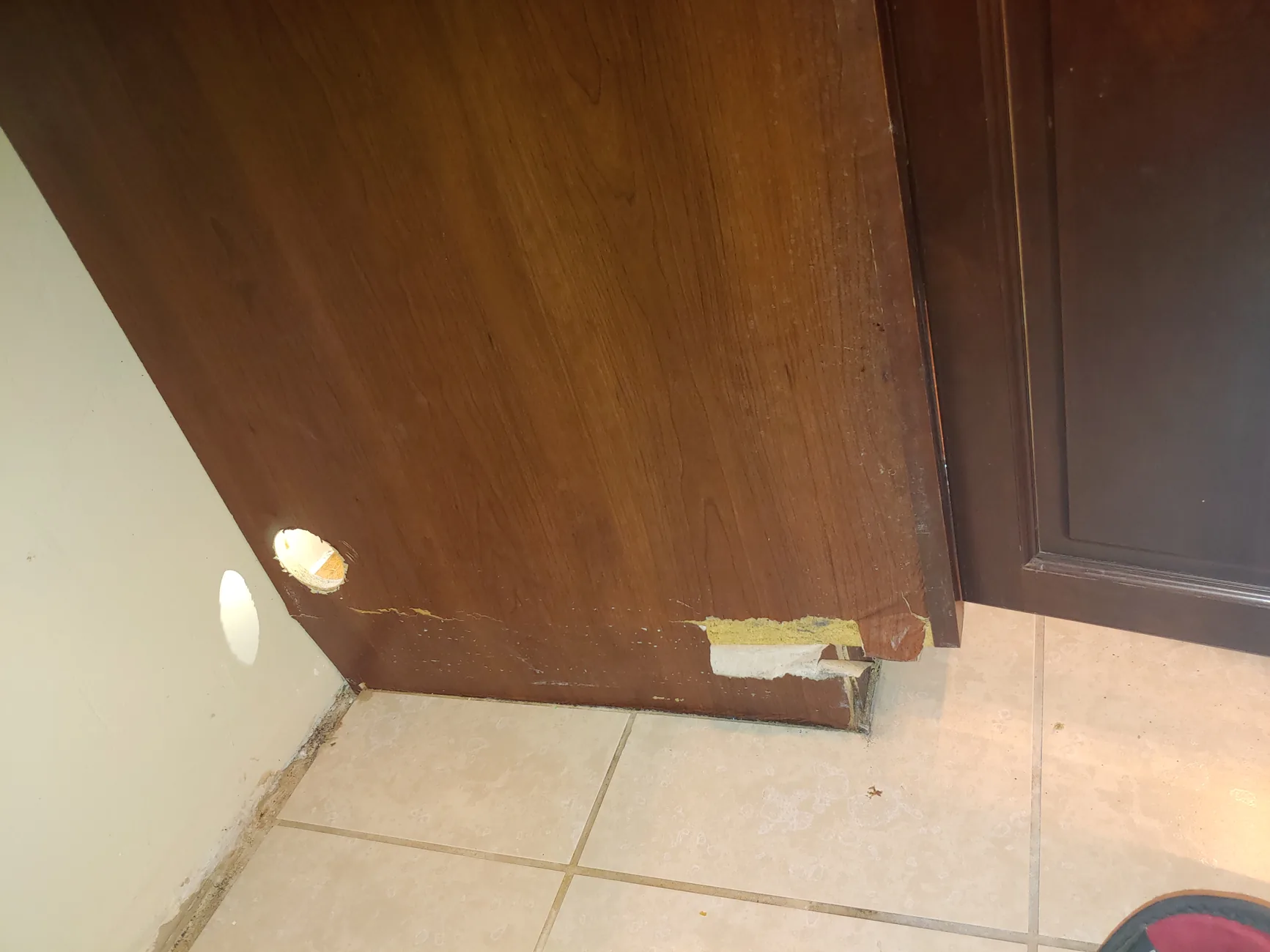 Water-damaged cabinet before repair
